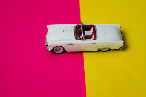 Sports car toy car model on a colourful background.Traveling and transport concept.
