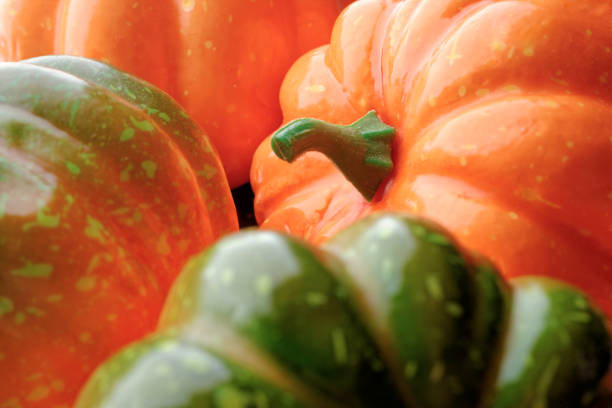 Group of orange and green pumpkins, closeup shot, seasonal background