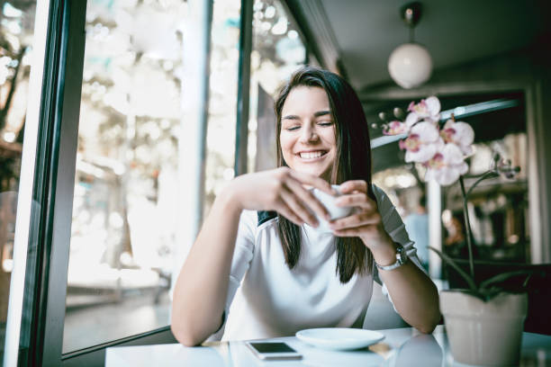 istock Cute Girl Drinking Coffee In Restaurant And Relaxing 1024163500