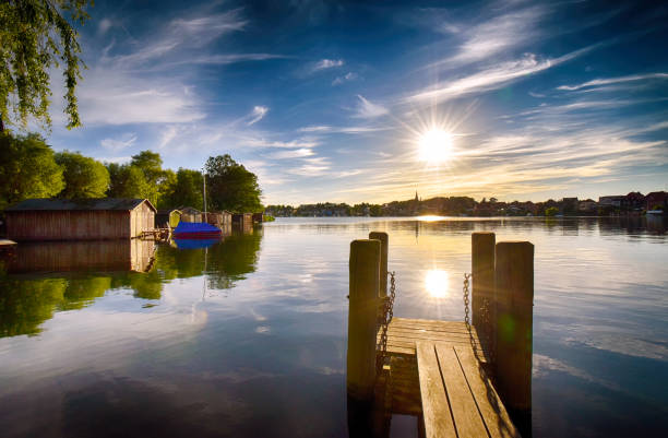 istock Sunset on the lake with jetty in Malchow (Mecklenburg-Vorpommern / Germany) 1024163630