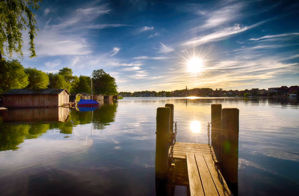 Sunset on the lake with jetty in Malchow (Mecklenburg-Vorpommern / Germany) Sunset on the lake with jetty in Malchow (Mecklenburg-Vorpommern / Germany) mecklenburg lake district photos stock pictures, royalty-free photos & images