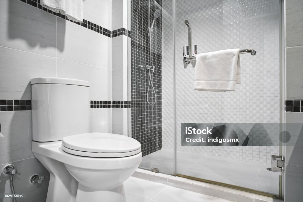 Concept of modern decoration design of bathroom for luxury hotel, residential Concept of modern decoration design of bathroom with toilet and shower decorating with black and white ceramic for luxury hotel, condominium, residential Toilet Stock Photo