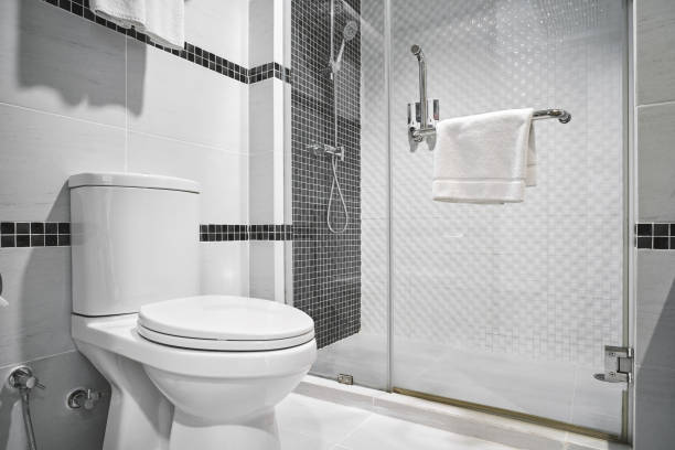 Concept of modern decoration design of bathroom for luxury hotel, residential Concept of modern decoration design of bathroom with toilet and shower decorating with black and white ceramic for luxury hotel, condominium, residential monochrome house stock pictures, royalty-free photos & images