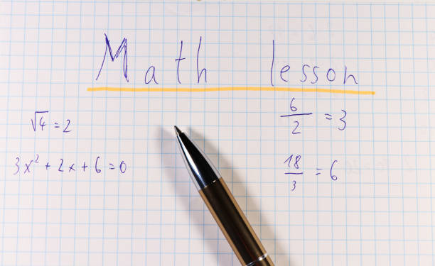 istock A title of square paper with golden pen. Title is math lesson because school is here 1024178620