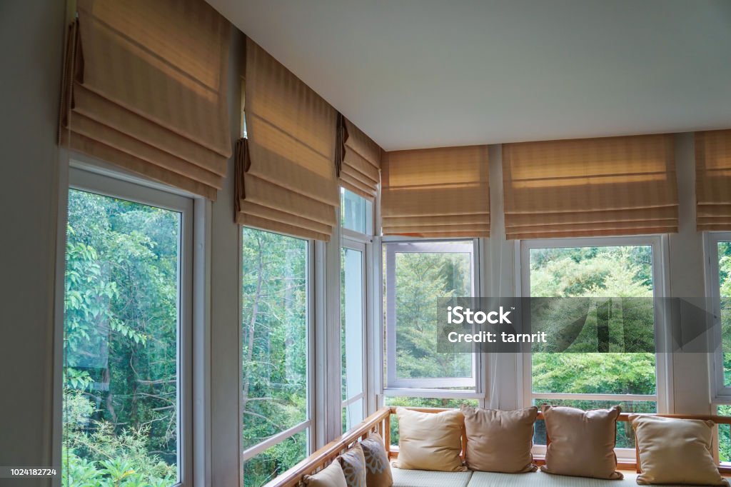 brown roman blind shade curtain tree forest mountain background living room Window Blinds Stock Photo