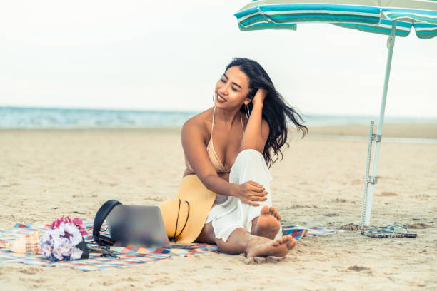 istock Plus size young woman sitting on the beach. 1024183324