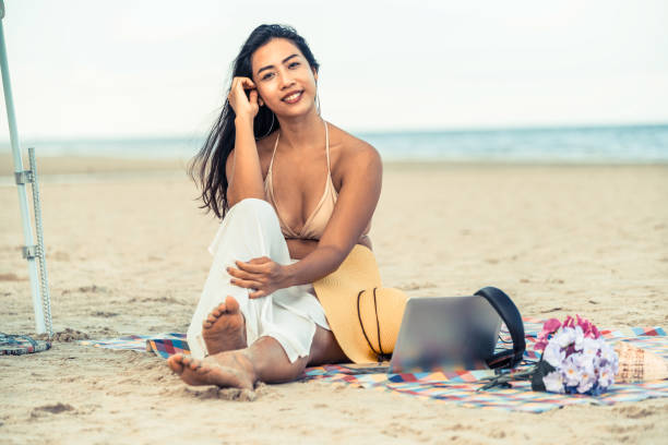 istock Plus size young woman sitting on the beach. 1024183390