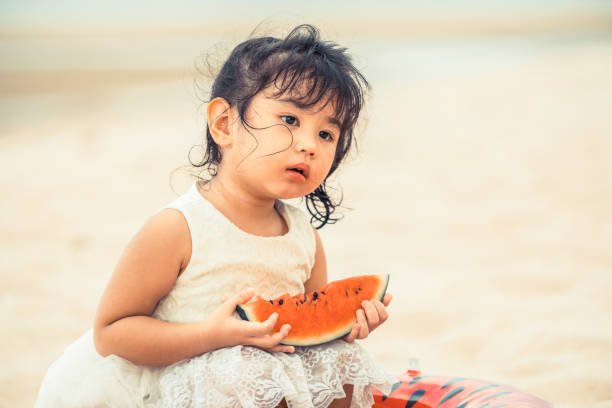 istock Adorable kid eating watermelon on the beach. 1024185818