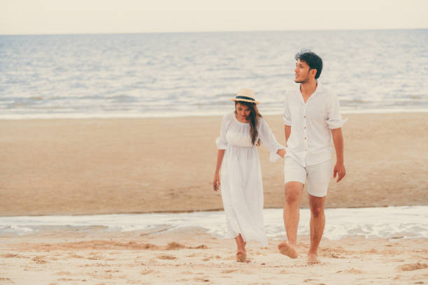 istock Happy young couple walk on the beach on honeymoon. 1024189026