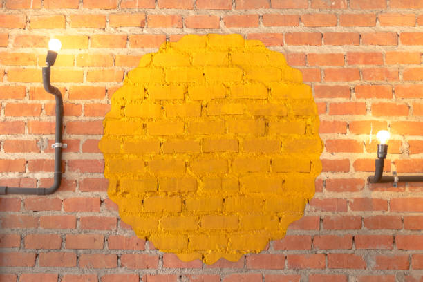 istock Yellow circle on the vintage brick wall with two light bulb for lighting 1024194116