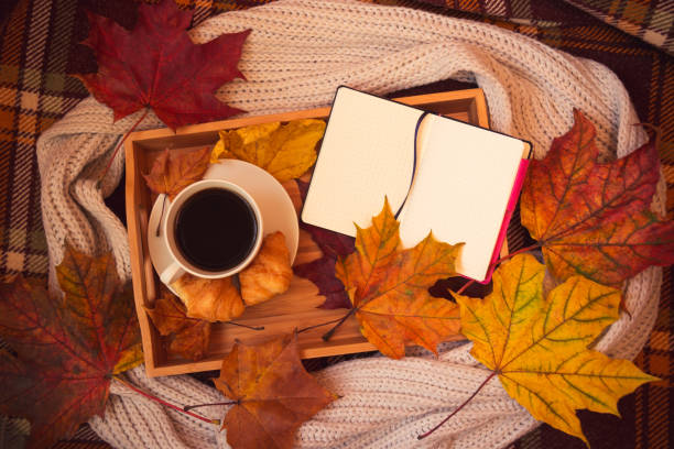 istock Coffee, crossants, opened notebook, gray scarf and autumn maple leaves 1024197020