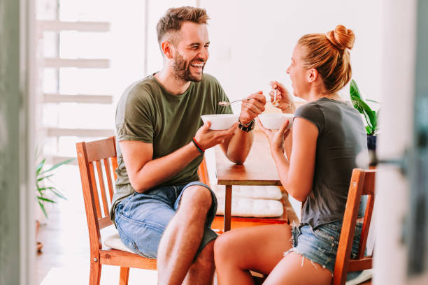 istock Young couple eating cereal breakfast at dining room table 1024197260