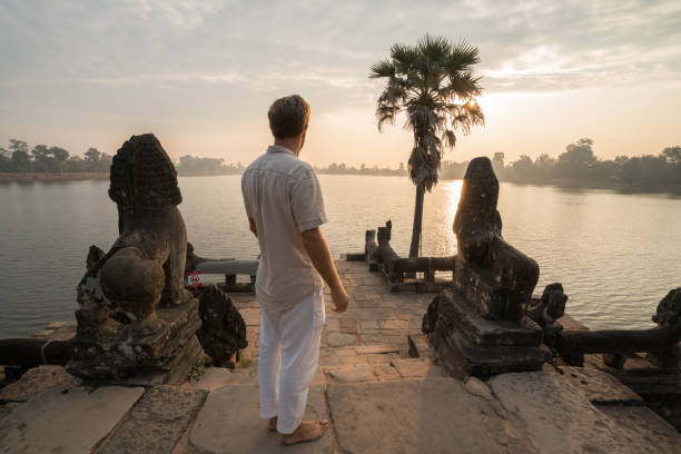 istock Young man contemplating ancient temple in Cambodia 1024197524