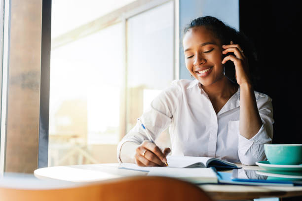 istock Woman entrepreneur working from cafe and talking on mobile phone 1024209136