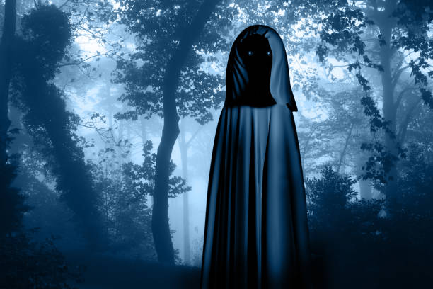 istock Spooky monster in hooded cloak in misty forest 1024215192
