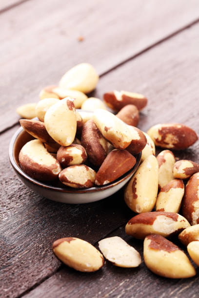 istock Para nuts on a rustic wooden table and para nuts in bowl 1024217648