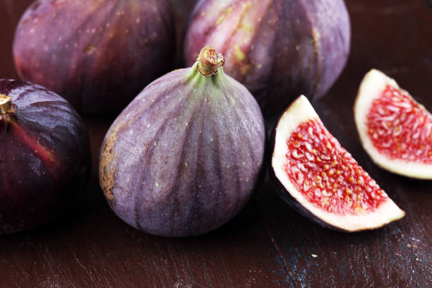 istock Fresh figs. Food Photo. whole and sliced figs on rustic background. 1024220954