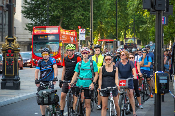 A crowd of cyclists waiting at traffic lights around Westminster, London London, UK - July 19, 2018 - A crowd of cyclists waiting at traffic lights around Westminster cycling vest photos stock pictures, royalty-free photos & images