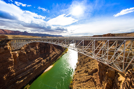 Navajo Bridge with green river and sand bars.