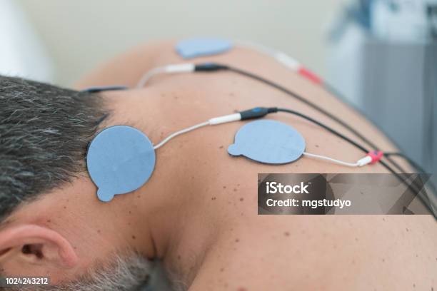 Man With Electrodes On Neck Stock Photo - Download Image Now - Back, Electrode, Men