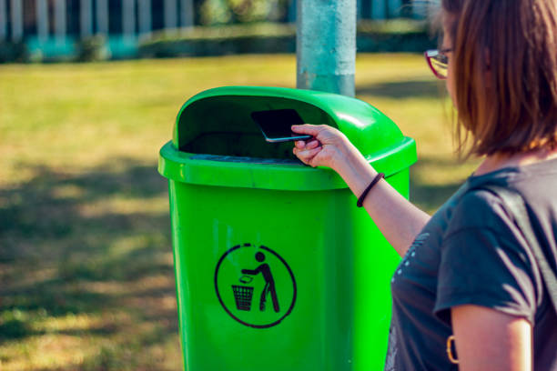 istock Girl throwing phone in the trash can 1024243376