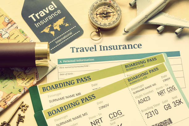 travel insurance and travel security service concept : top view of travel insurance application form, business class boarding passes, map, monocular, tag, compass, white model air plane on wood floor. - airplane air vehicle business travel passenger imagens e fotografias de stock