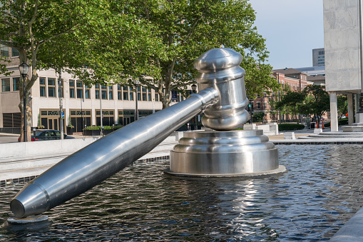 COLUMBUS, OH - JUNE 17, 2018: Stainless steel gavel sculpture created by Andrew Scott located in the courtyard of the Ohio Judicial Center in downtown Columbus, Ohio
