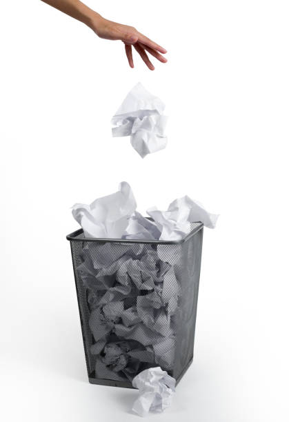 istock Woman hand putting paper in a bin, on white background. 1024251346