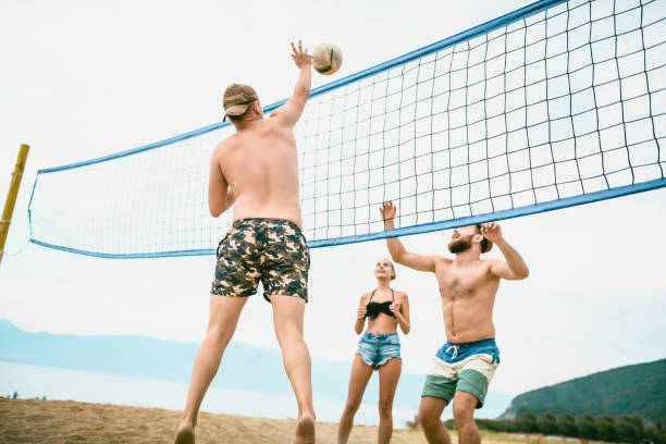 istock Cute Friends Playing Beach Volleyball 1024254336