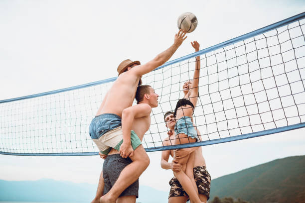 istock Cute Friends Playing Together At The Beach 1024256438