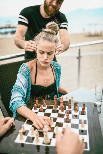 istock Cute Female Playing Chess With Friends At The Beach 1024256558