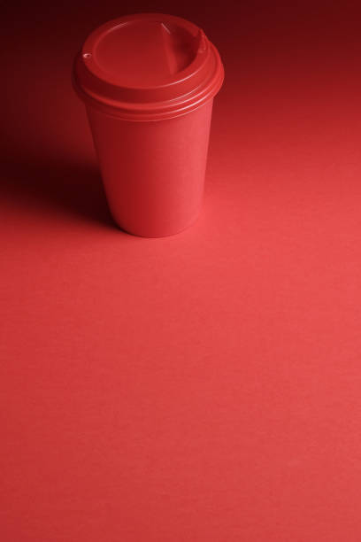 istock Red plastic coffee cup on a red background with a red lid 1024256632