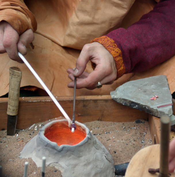 istock Master glass blower making beads. Ancient crucible, horn and fur. 1024260472