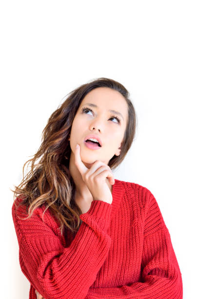 istock Young girl with thoughtful face looking up 1024262368