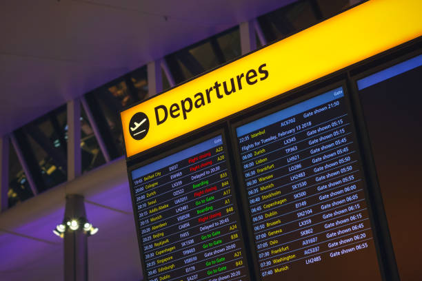 Departure board displaying flight information at departure hall of London Heathrow airport London, UK - August 12, 2018 - Departure board displaying time, destination cities and gate information in London Heathrow airport delayed sign photos stock pictures, royalty-free photos & images