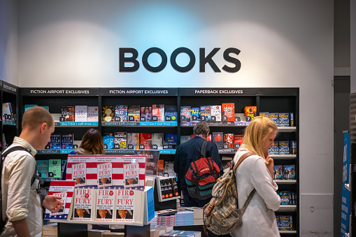 London, UK - August 12, 2018 - Travellers browsing in a bookshop at London Heathrow Airport terminal 5