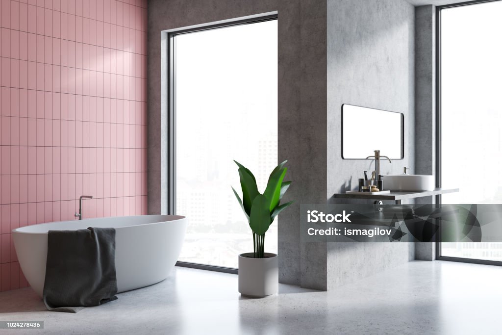 Gray and pink tile bathroom corner Attic bathroom interior with concrete and pink tile walls and floor, a bathtub, and a sink. Loft windows 3d rendering Apartment Stock Photo