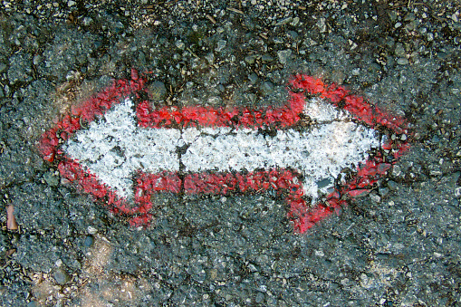 arrows on the asphalt for the orientation of the walker while walking along the path