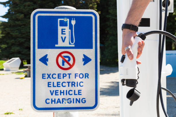istock Person Using Electric Car Charging Station 1024313780