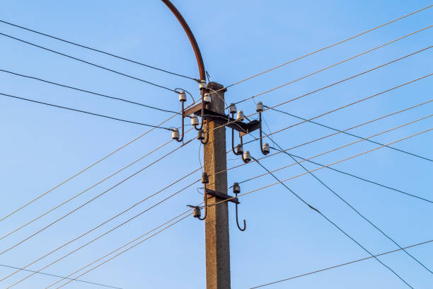 istock Electric pole power lines and wires with blue sky 1024316768