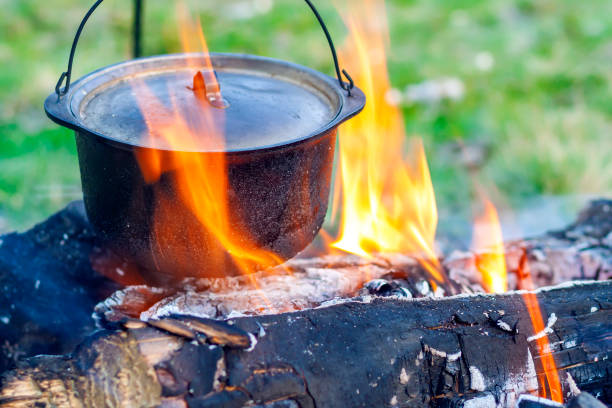 istock Camping kitchenware - pot on the fire at an outdoor campsite 1024316800
