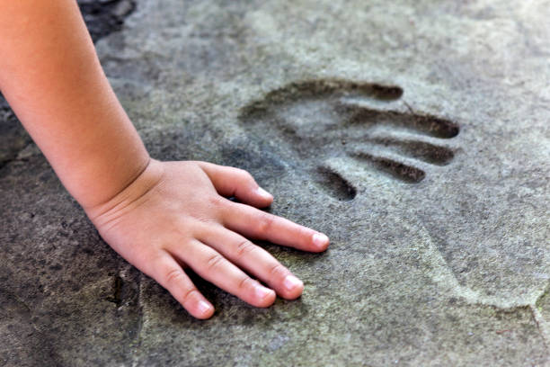 Childs hand and memorable handprint in  concrete