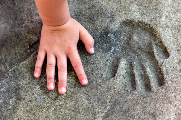 istock Childs hand and memorable handprint in  concrete 1024316874