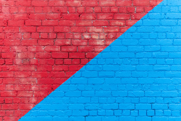 Divided red and blue brick wall background stock photo