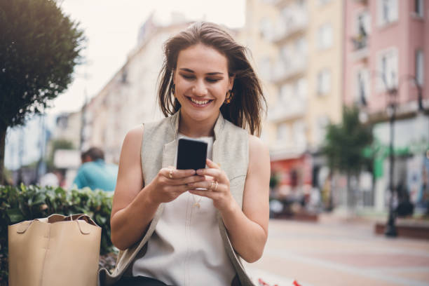 istock Young happy woman texting 1024322122