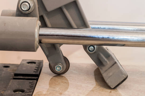istock Ceramic tiles and tools for tiler. Floor tiles installation. Home improvement, renovation - ceramic tile cutting tool. 1024328390