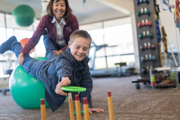 istock A boy does workouts with an occupational therapist at a physiotherapy clinic 1024328814