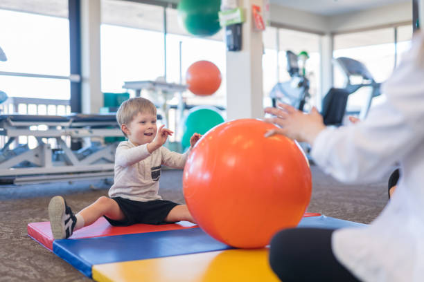 istock Young boy exercising in physiotherapy clinic 1024328854