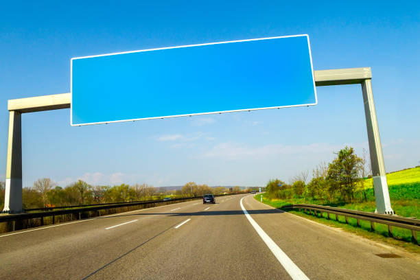 istock Blank blue freeway sign over the road on sunny day 1024334088