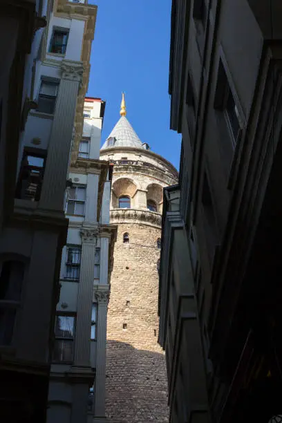 Picture of the Galata tower, in the Galatasaray district, in Istanbul, the Turkish biggest city, surrounded by old buildings. The Galata Tower is a medieval stone tower in the Galata-Karakoy quarter of Istanbul, Turkey